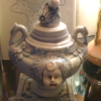 What are these?  Vases with faces and perfume bottle with faces and herons?!