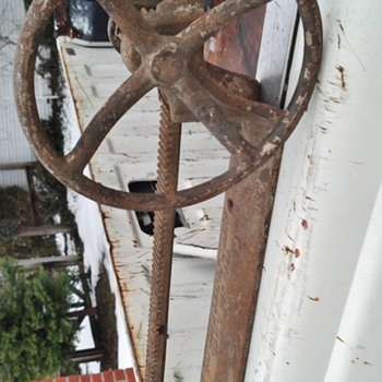 Wall mounted crank operated late 1800's cast iron contraption