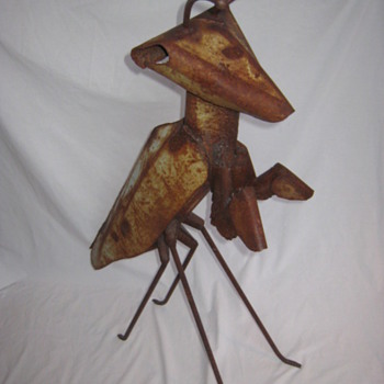 rustic folk art sculpture of a praying Mantis