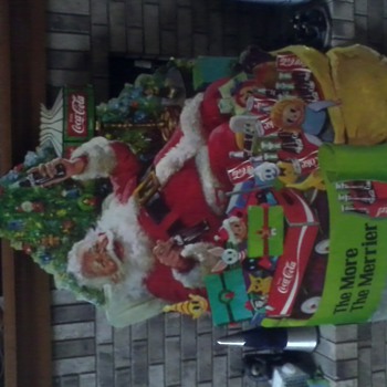 Coke Santa sitting by Christmas tree poster
