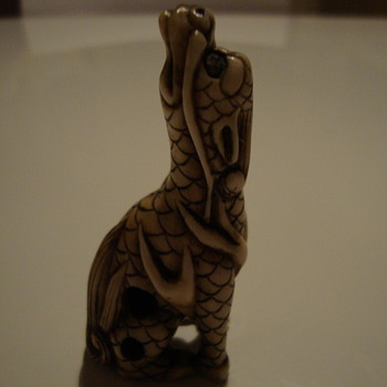 twisted dragon netsuke signed at the bottom