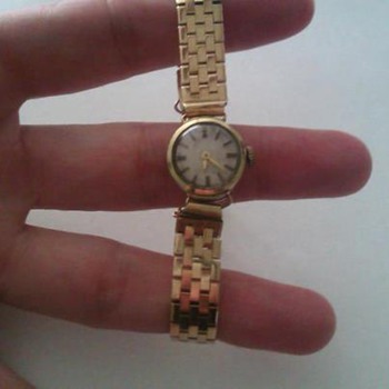 14 karat from Grandma (she got it in 1943) I believe it is a doxa..
