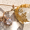 Beautiful earrings gold globes with a Diamond maybe