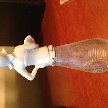 Mystery perfume bottle: porcelain figure top, glass bottle