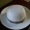 Women's off-white hat with matching off-white and black band with a bow.