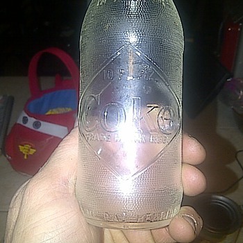 Pics of vintage looking coke bottle. Looking to know what era its from and what its value would be?