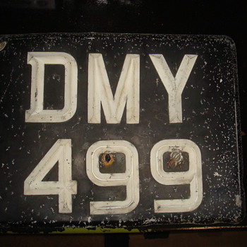 Looks like some kind of license plate. - Signs