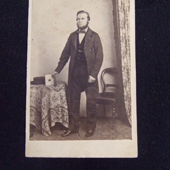 CDV of man with photo album showing image - Photographs