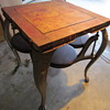 Very old steel table with 4 swing out seats