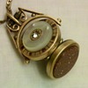 Spinning Watch Fob Locket w/Mother of Pearl, Rubies, and Sandstone.