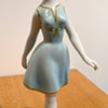 A HOLLOHAZA PORCELAIN FIGURINE OF A 1950'S WOMAN