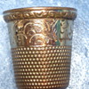 Gold thimble with a star and the number 12 inside
