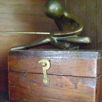 bronze of boy holding foot