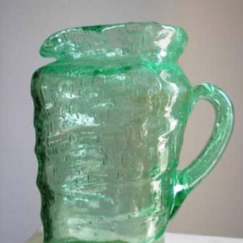 Triangular Green glass pitcher that seems older than most