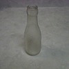 A SMALL OVERSHOT GLASS BOTTLE