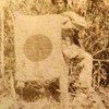 Original WW II Photo of a U.S. Marine Holding a Captured Japanese Flag
