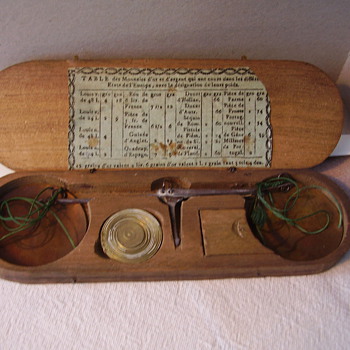 A very old French hand weight scale.
