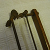 Unidentifiable spring bar with ratchet and mounted on wooden base