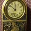 Small brass windup clock