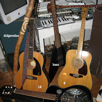 A group of guitars and stuff. - Guitars