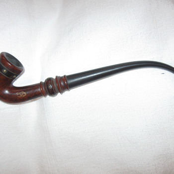 Antique long stem tobacco pipe.