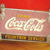 Help me identify this Coke sign