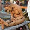 Stoneware Figure of a Slouched Man Sitting on the Floor