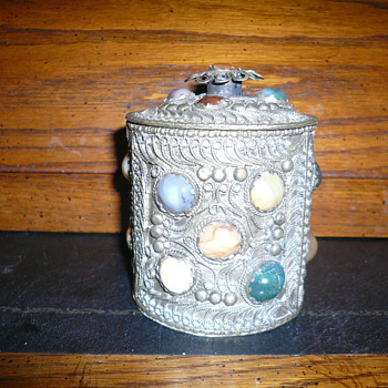 metal can with stones on and a lid