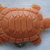 An early plastic dress clip like a little coral turtle