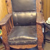 antique rocker with lion engravings and leather upholstry.