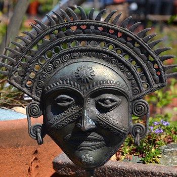 Brass Mask mounted on a stand
