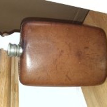 A couple old hip flasks left in grandmothers cabinet and a camera