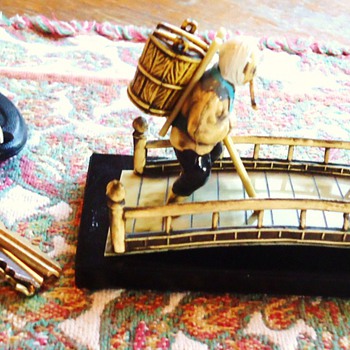 Japanese sculpture?  made of plastic? hand painted on wood platform. What is this????