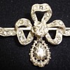 A silver and gold rose cut diamond Victorian bow brooch