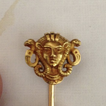 Gold pin with head of deity