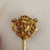 Gold pin with head of deity
