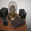 Small camera collection and grandmas clock.