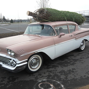 My driver carrying our Christmas tree!  Fun day...  But we love the German cars too!