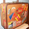 Old suitcase covered in luggage labels from all over Europe