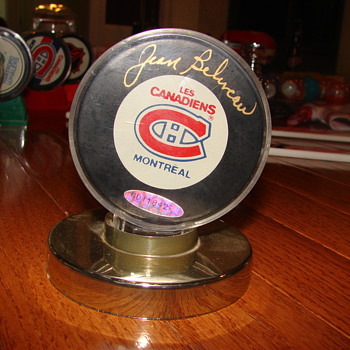 Jean Beliveau signed and numbered hockey puck. 