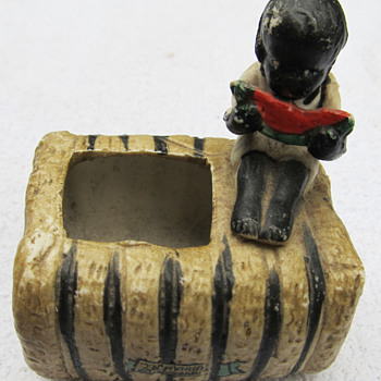 BLACK BOY ON COTTON BALE EATING WATERMELON - Pottery