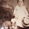 Cabinet card of boy in dress with a cat 