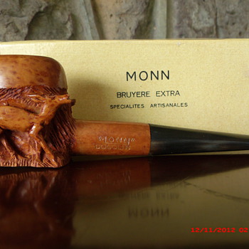 A very nice hand carved pipe with three deer carvings.
