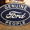 vintage "Genuine Ford People" steel sign