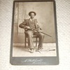 Cabinet card of African American Man with Winchester Rifle