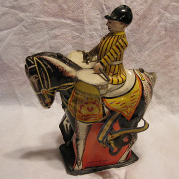 Tin or Metal drummer on a wind-up horse with key