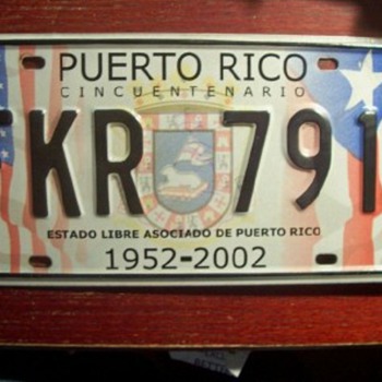 CONTROVERSIAL PUERTO RICO 5OTH ANNIVERSARY LICENSE PLATE FROM 2002 - Signs