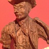 A hand carved wooden cowboy 