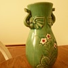Vase with elephant heads, flowers and greenery