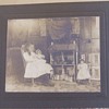 Photograph of Girl with dolls and doll house